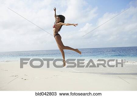 South American woman jumping on beach View Large Photo Image Stock Image - South American woman jumping on beach. Fotosearch