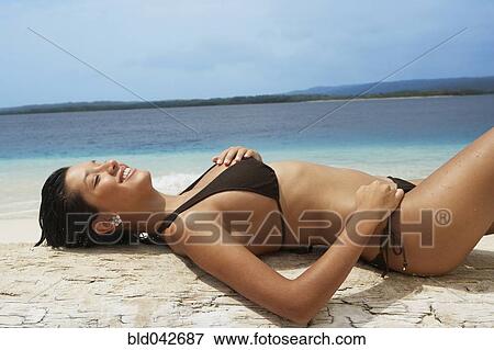 South American woman laying on beach View Large Photo Image Stock Photo - South American woman laying on beach. Fotosearch
