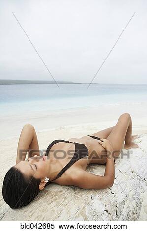 South American woman laying on beach View Large Photo Image Stock Photography - South American woman laying on beach. Fotosearch