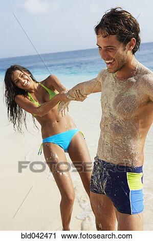South American woman pulling boyfriend at beach View Large Photo Image Stock Image - South American woman pulling boyfriend at beach. Fotosearch