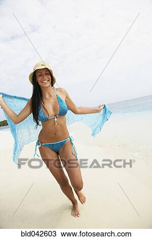 South American woman walking on beach View Large Photo Image Stock Image - South American woman walking on beach. Fotosearch