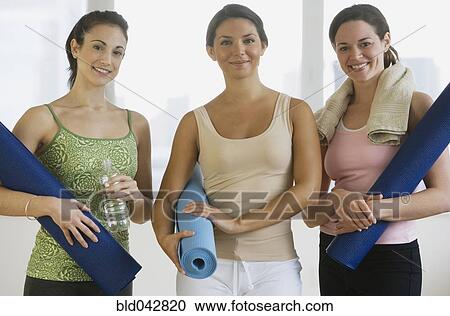 Three young women in yoga class View Large Photo Image Stock Image - Three young women in yoga class. Fotosearch