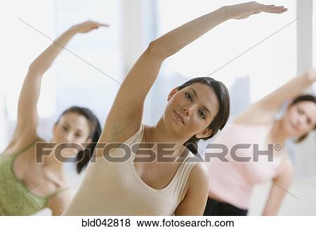 Three young women in yoga class View Large Photo Image Stock Photo - Three young women in yoga class. Fotosearch