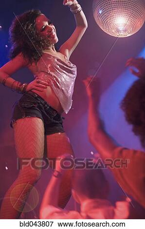 Stock Photo - Woman dancing at nightclub. Fotosearch