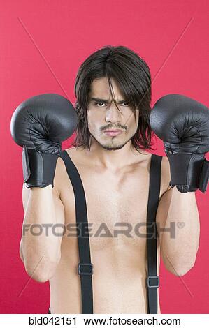 Young Hispanic man wearing boxing gloves View Large Photo Image Stock Image - Young Hispanic man wearing boxing gloves. Fotosearch