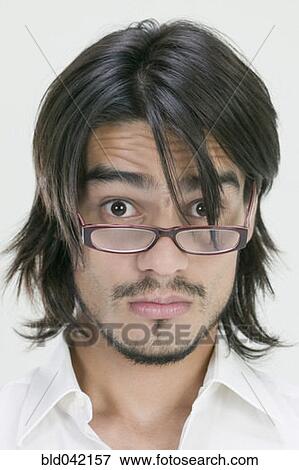Young Hispanic man wearing eyeglasses View Large Photo Image Stock Photo - Young Hispanic man wearing eyeglasses. Fotosearch