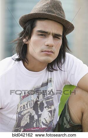 Young Hispanic man wearing hat View Large Photo Image Stock Image - Young Hispanic man wearing hat. Fotosearch