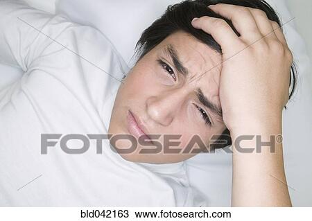 Young Hispanic man with hand on head View Large Photo Image Stock Image - Young Hispanic man with hand on head. Fotosearch