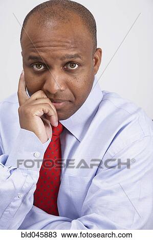 African American businessman leaning chin on hand View Large Photo Image Stock Image - African American businessman leaning chin on hand. Fotosearch