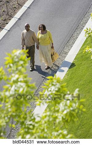 Stock Image - African American couple holding hands. Fotosearch