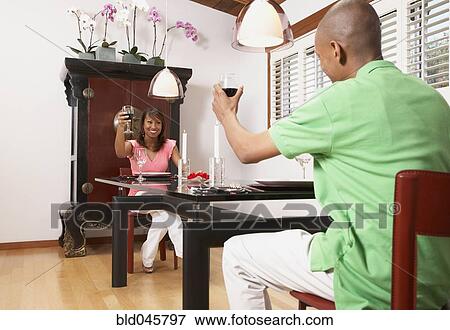 Stock Photo - African American couple toasting with wine. Fotosearch