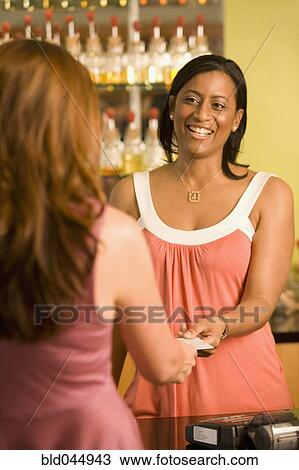 African American female sales clerk taking credit card View Large Photo Image Stock Image - African American female sales clerk taking credit card. Fotosearch