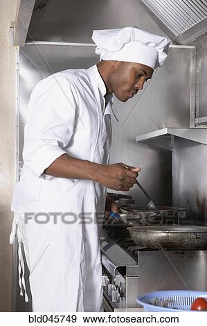 Stock Photo - African American male chef preparing food. Fotosearch