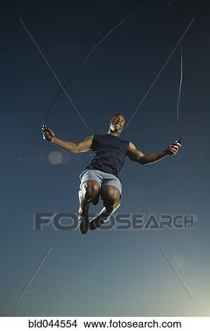 Picture - African American man jumping rope. Fotosearch