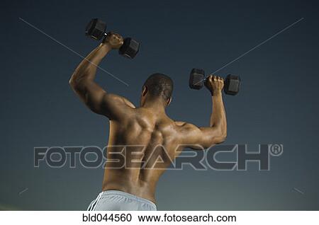Stock Image - African American man lifting weights. Fotosearch