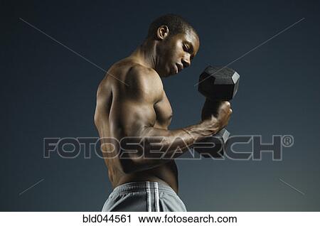 Stock Image - African American man lifting weights. Fotosearch