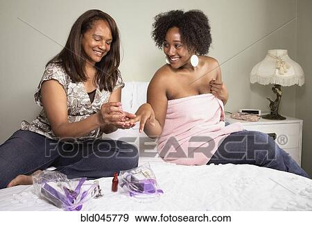 African American mother painting daughter's fingernails View Large Photo Image Stock Photo - African American mother painting daughter's fingernails. Fotosearch