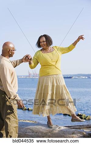 African American woman holding husband’s hand for balance View Large Photo Image Stock Photography - African American woman holding husband’s hand for balance. Fotosearch