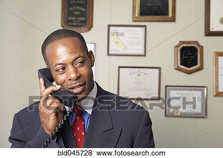 African businessman talking on telephone View Large Photo Image Stock Photo - African businessman talking on telephone. Fotosearch