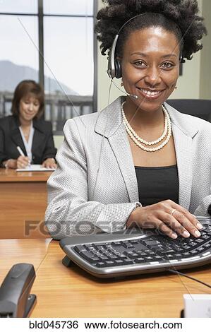 African businesswoman wearing headset View Large Photo Image Stock Photograph - African businesswoman wearing headset. Fotosearch