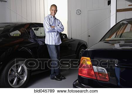African man leaning on car View Large Photo Image Stock Photo - African man leaning on car. Fotosearch