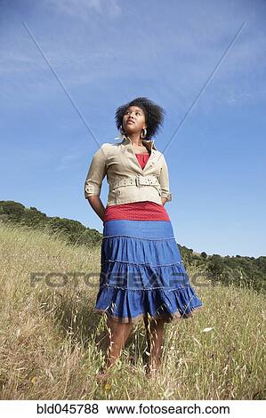 African woman standing in field View Large Photo Image Stock Photo - African woman standing in field. Fotosearch
