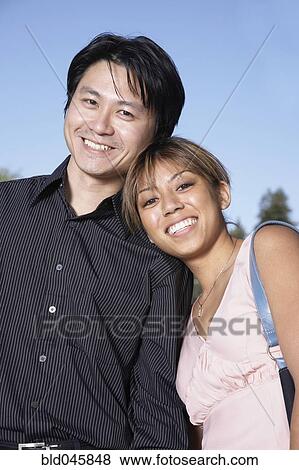 Asian couple hugging View Large Photo Image Stock Photo - Asian couple hugging. Fotosearch