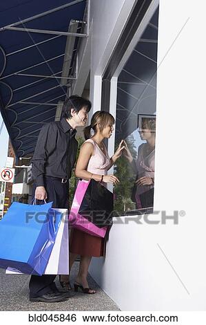 Asian couple window shopping View Large Photo Image Stock Photograph - Asian couple window shopping. Fotosearch