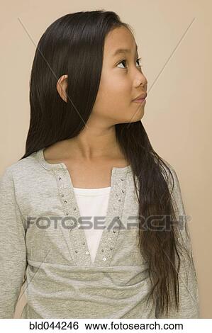 Stock Photograph - Asian girl looking to side. Fotosearch