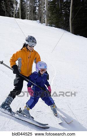 Stock Photography - Asian mother and daughter skiing. Fotosearch