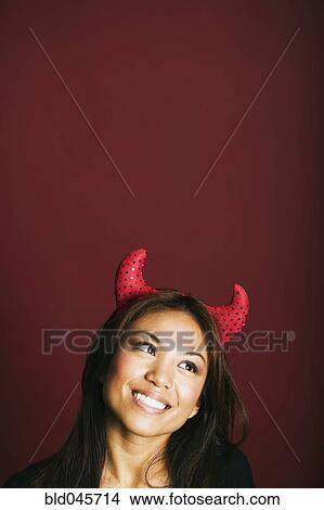 Asian woman wearing devil’s horns View Large Photo Image Picture - Asian woman wearing devil’s horns. Fotosearch
