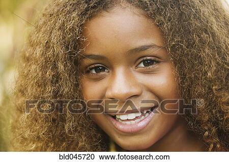 Close up of African American girl smiling View Large Photo Image Stock Image - Close up of African American girl smiling. Fotosearch