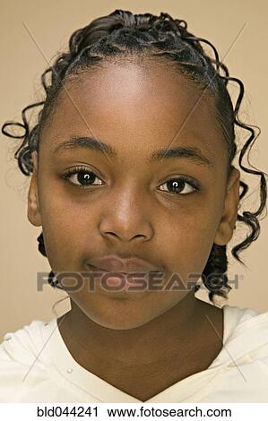 Stock Image - Close up of African American girl’s face. Fotosearch