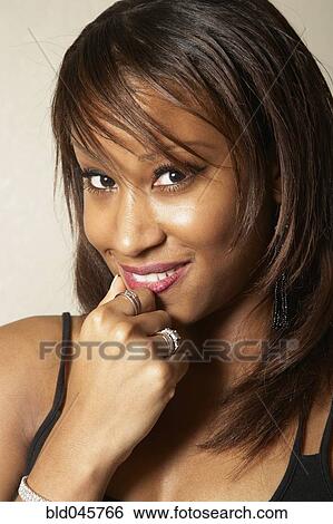 Stock Photograph - Close up of African American woman smiling. Fotosearch