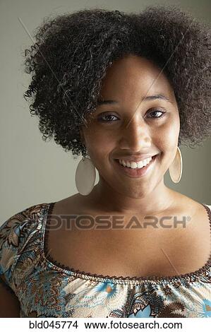 Picture - Close up of African woman smiling. Fotosearch