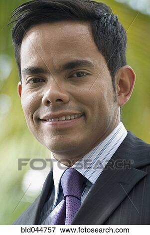 Stock Photo - Close up of Hispanic businessman smiling. Fotosearch