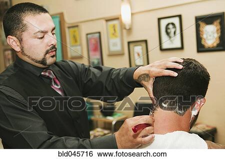 Hispanic barber shaving man’s neck View Large Photo Image Stock Photograph - Hispanic barber shaving man’s neck. Fotosearch
