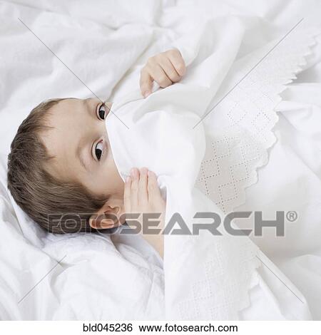 Hispanic boy hiding under covers View Large Photo Image Stock Photograph - Hispanic boy hiding under covers. Fotosearch