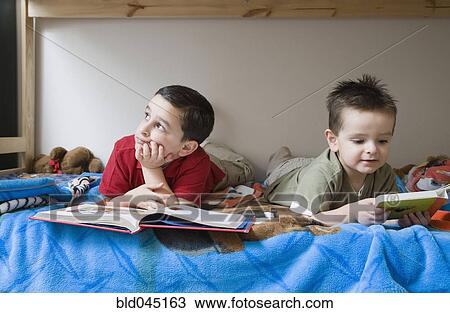 Hispanic brother reading in bed View Large Photo Image Stock Image - Hispanic brother reading in bed. Fotosearch