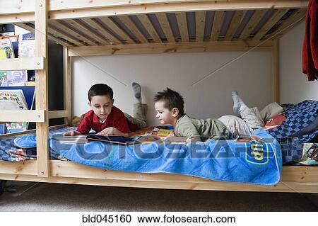 Hispanic brothers reading in bed View Large Photo Image Stock Image - Hispanic brothers reading in bed. Fotosearch