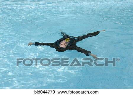 Stock Photo - Hispanic businessman in swimming pool. Fotosearch