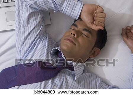 Hispanic businessman laying on bed View Large Photo Image Stock Image - Hispanic businessman laying on bed. Fotosearch