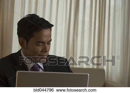 Stock Photograph - Hispanic businessman looking down. Fotosearch