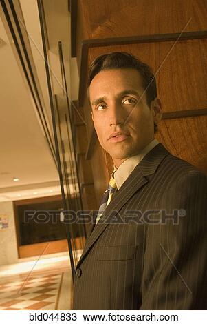 Stock Image - Hispanic businessman looking sideways. Fotosearch