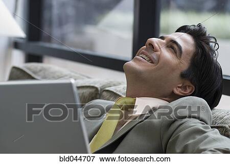 Stock Photo - Hispanic businessman on sofa. Fotosearch