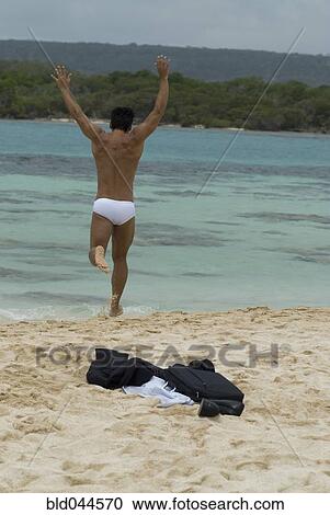 Hispanic businessman running into water View Large Photo Image Stock Image - Hispanic businessman running into water. Fotosearch