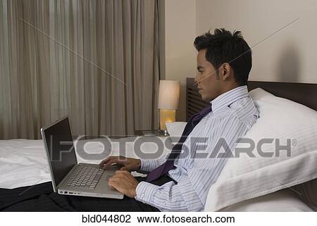 Stock Image - Hispanic businessman typing on laptop. Fotosearch