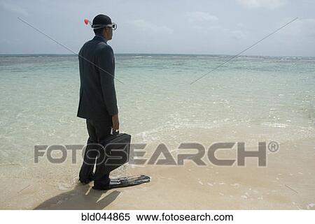 Stock Photography - Hispanic businessman wearing snorkeling gear. Fotosearch