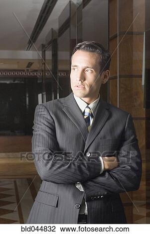 Stock Image - Hispanic businessman with arms crossed. Fotosearch