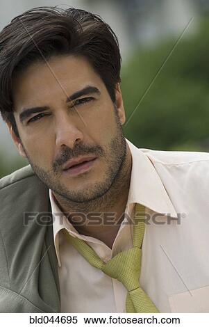 Hispanic businessman with jacket over shoulder View Large Photo Image Stock Photography - Hispanic businessman with jacket over shoulder. Fotosearch